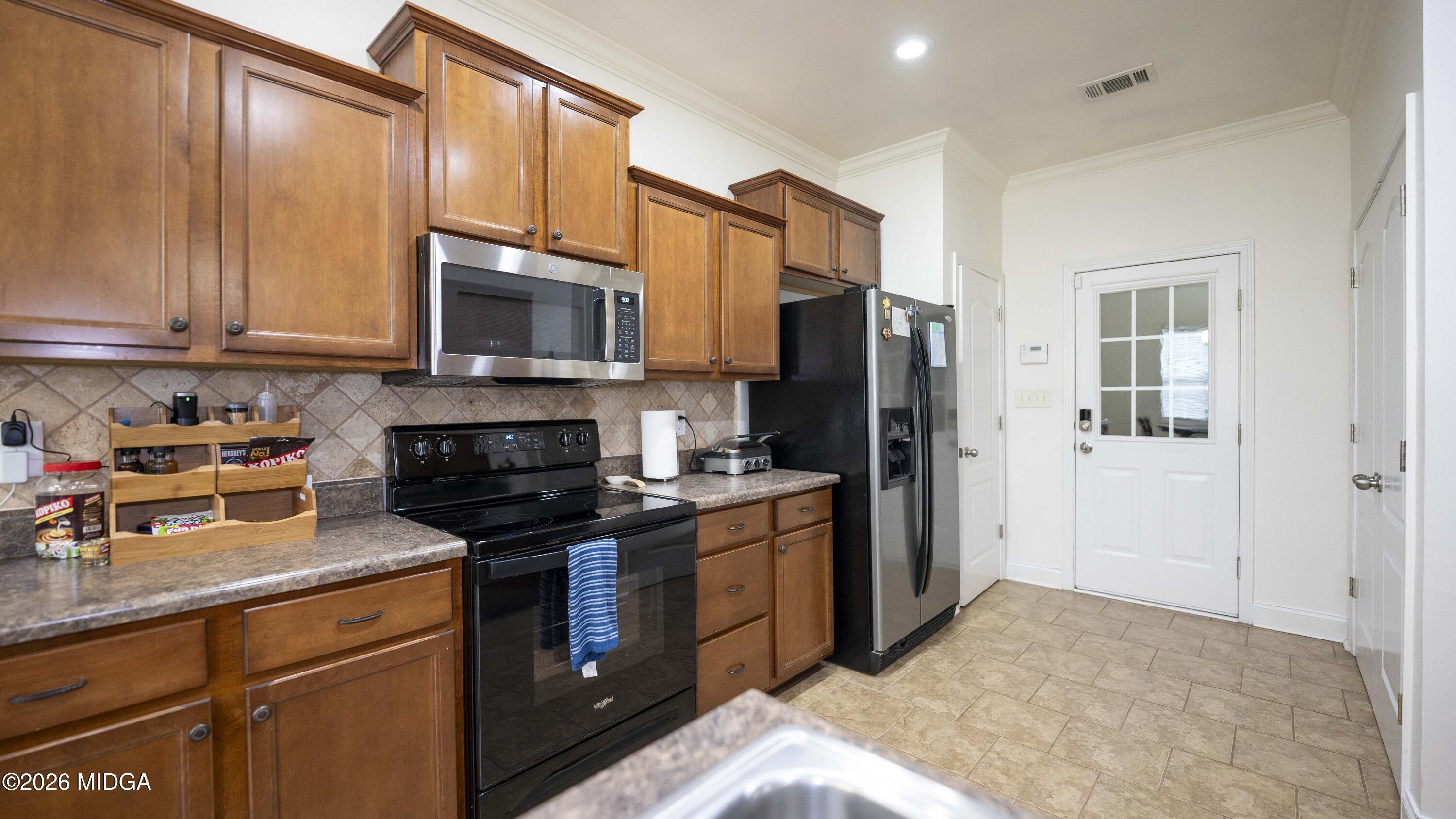 207 Broderick Circle Warner Robins, GA 31088 - Photo 16 of 33 a kitchen with a sink stove and refrigerator