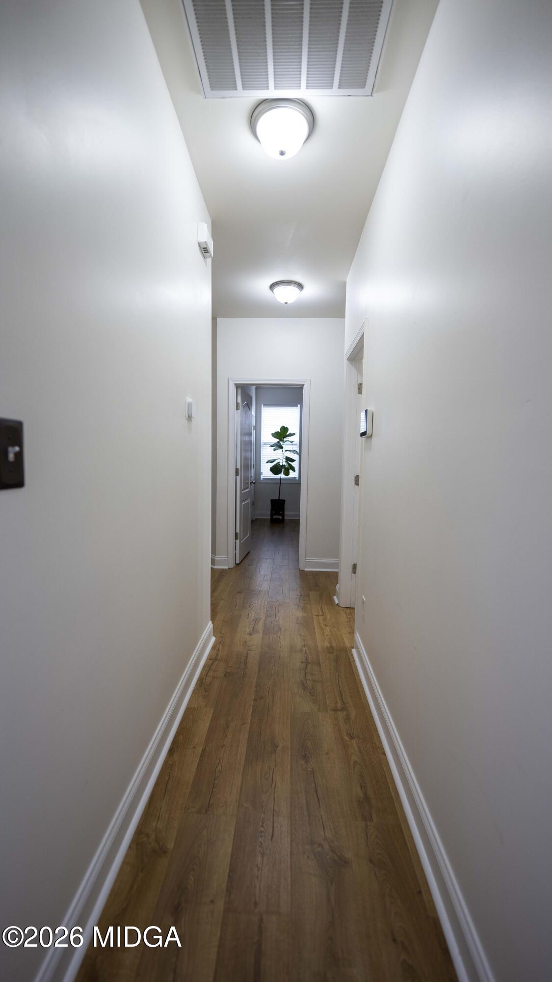 207 Broderick Circle Warner Robins, GA 31088 - Photo 18 of 33 wooden floor in an empty room with a window