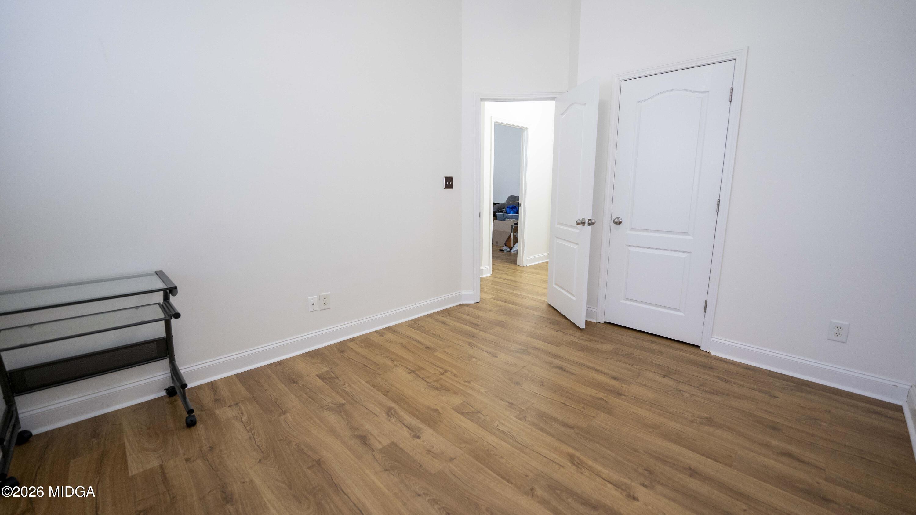 207 Broderick Circle Warner Robins, GA 31088 - Photo 20 of 33 a view of an empty room with wooden floor and a window