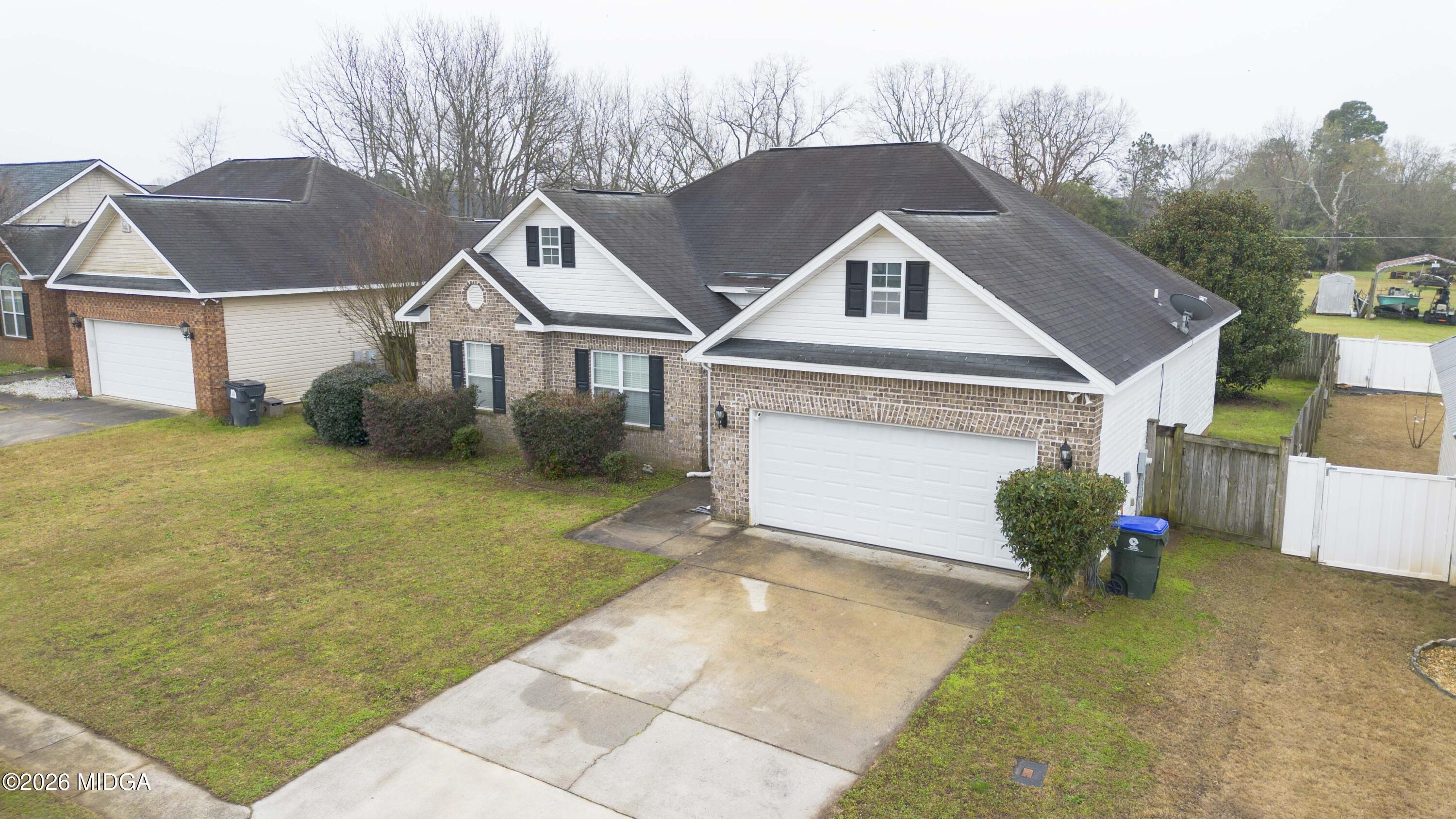 207 Broderick Circle Warner Robins, GA 31088 - Photo 2 of 33 a front view of a house with a yard and garage