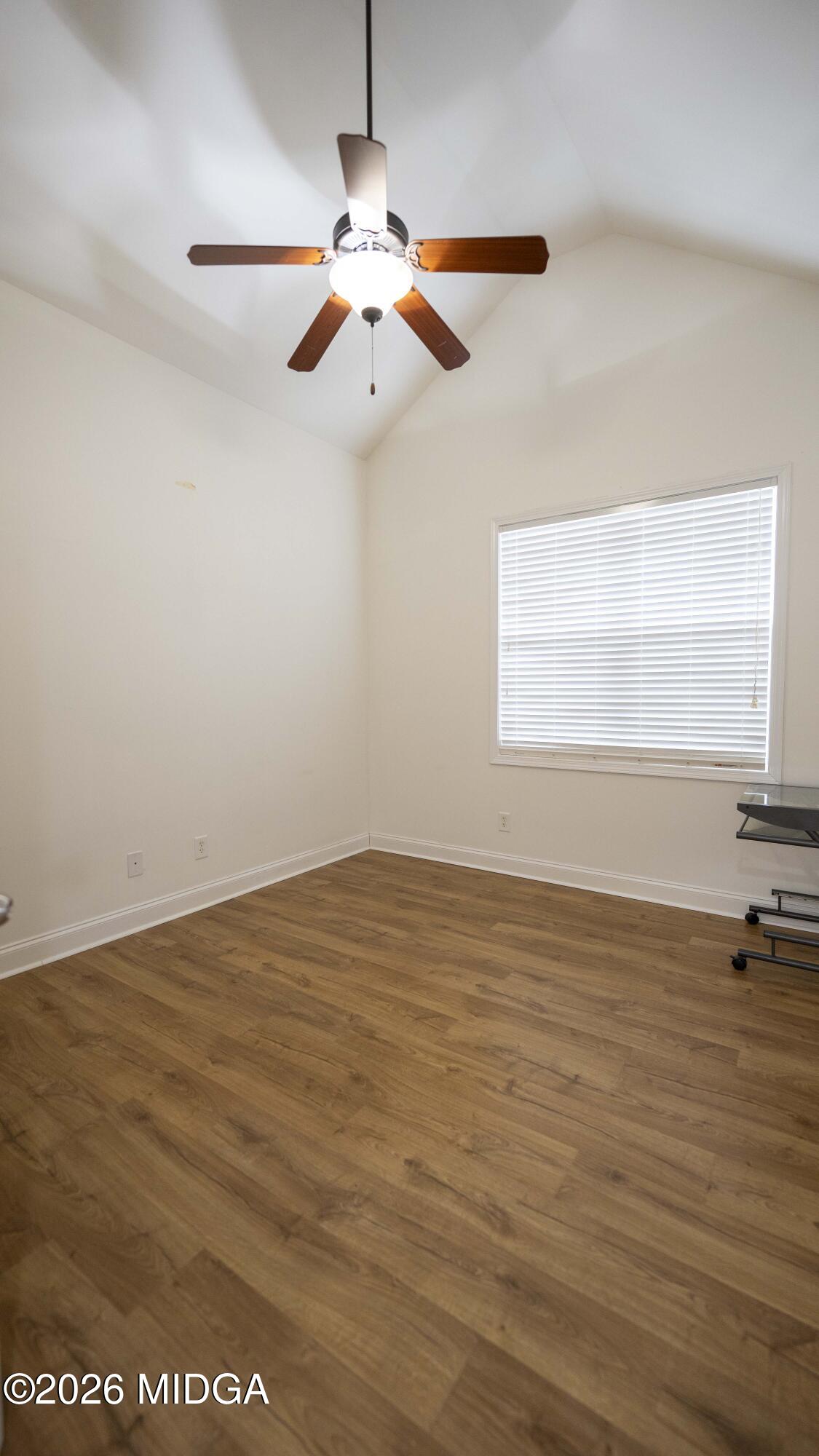 207 Broderick Circle Warner Robins, GA 31088 - Photo 21 of 33 an empty room with wooden floor fan and windows