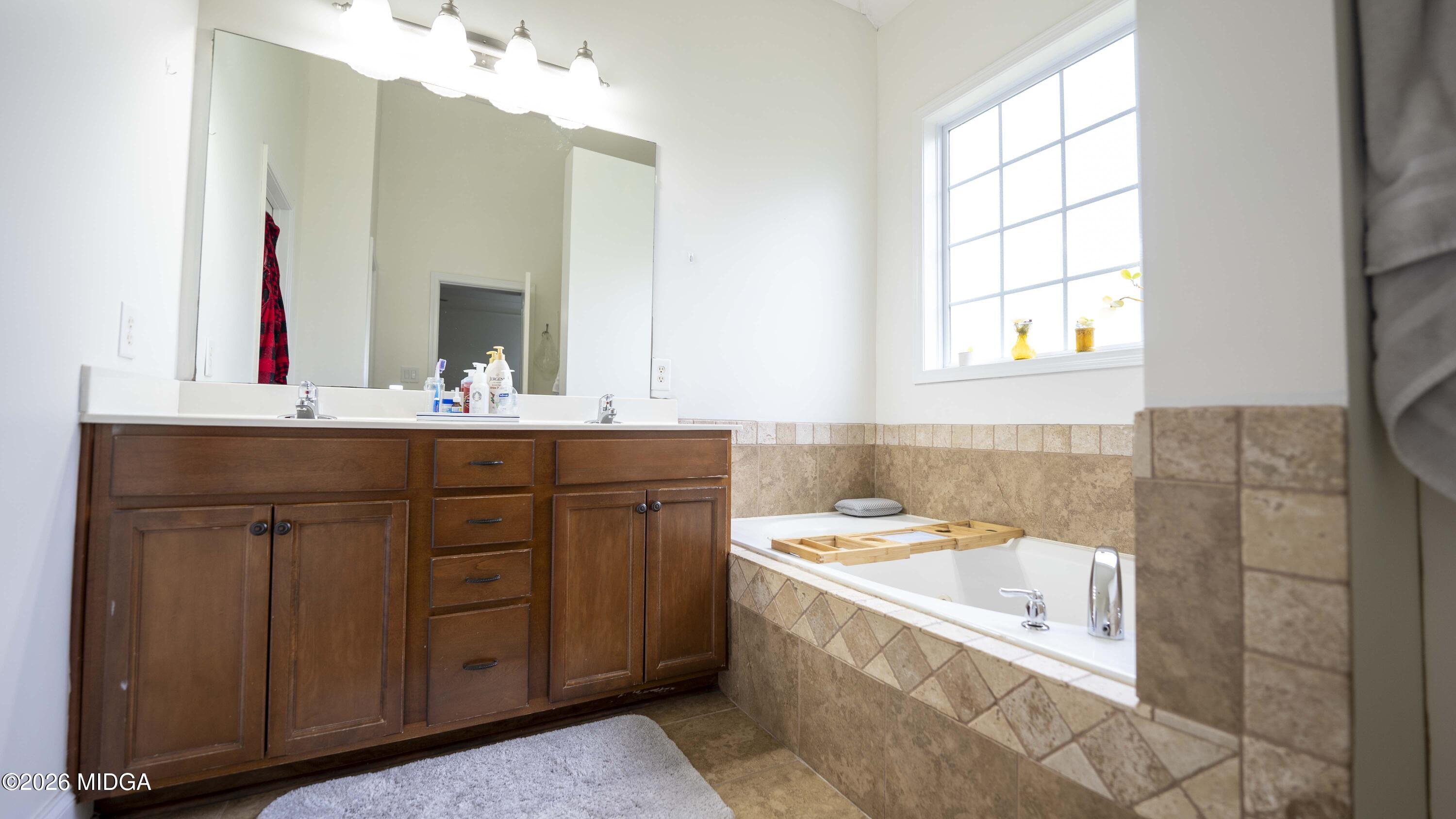 207 Broderick Circle Warner Robins, GA 31088 - Photo 24 of 33 a bathroom with a granite countertop sink mirror and bathtub