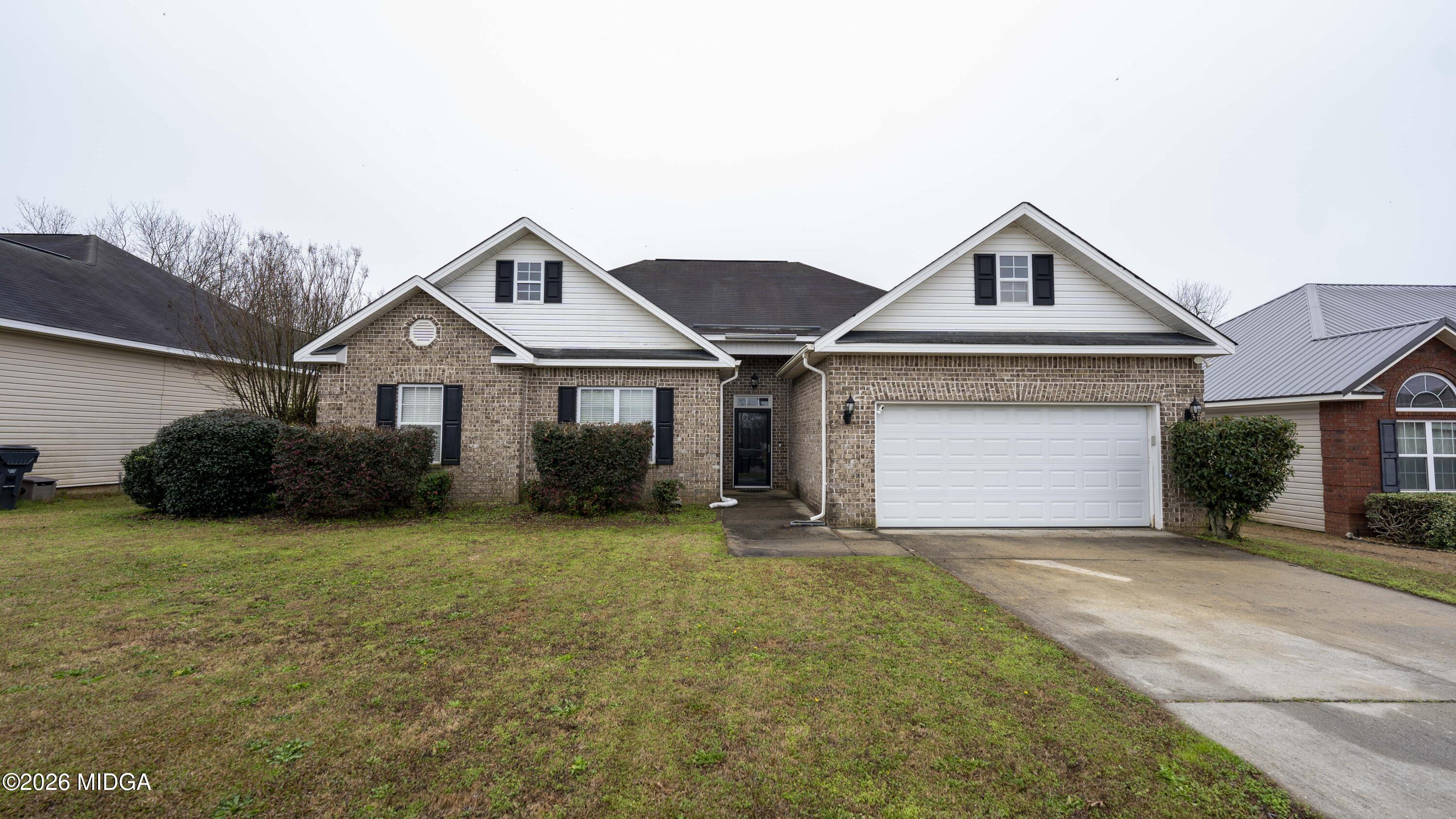 207 Broderick Circle Warner Robins, GA 31088 - Photo 6 of 33 a front view of a house with a yard and garage