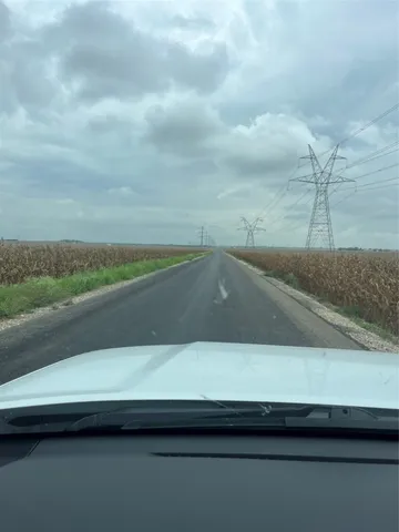 a view of a balcony next to a yard