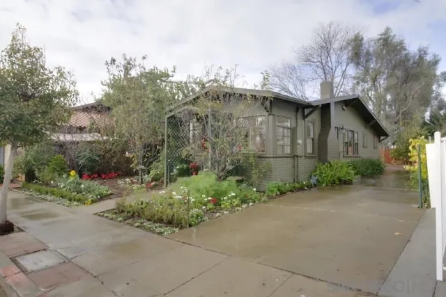 a pathway of a house with a yard