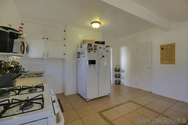 a view of a kitchen with refrigerator and stove