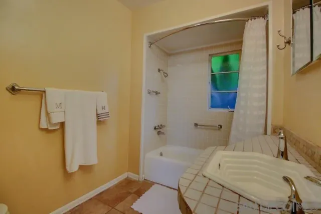 a bathroom with a bathtub and shower
