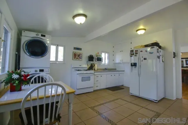 a kitchen with a refrigerator and cabinets