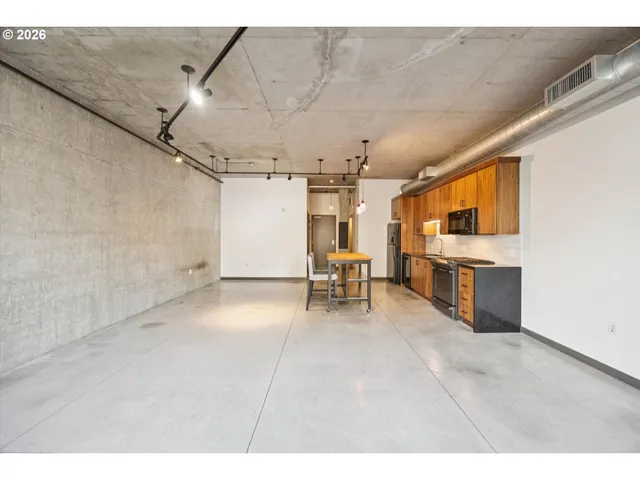a view of a livingroom with furniture and a window