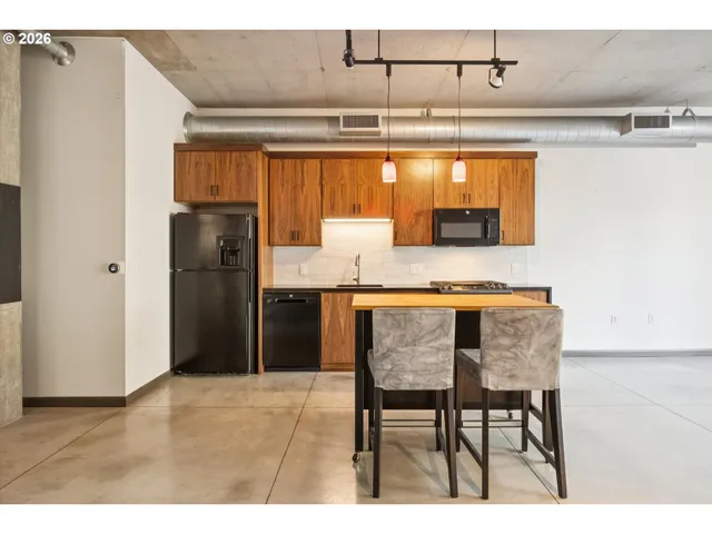 a kitchen with refrigerator and cabinets