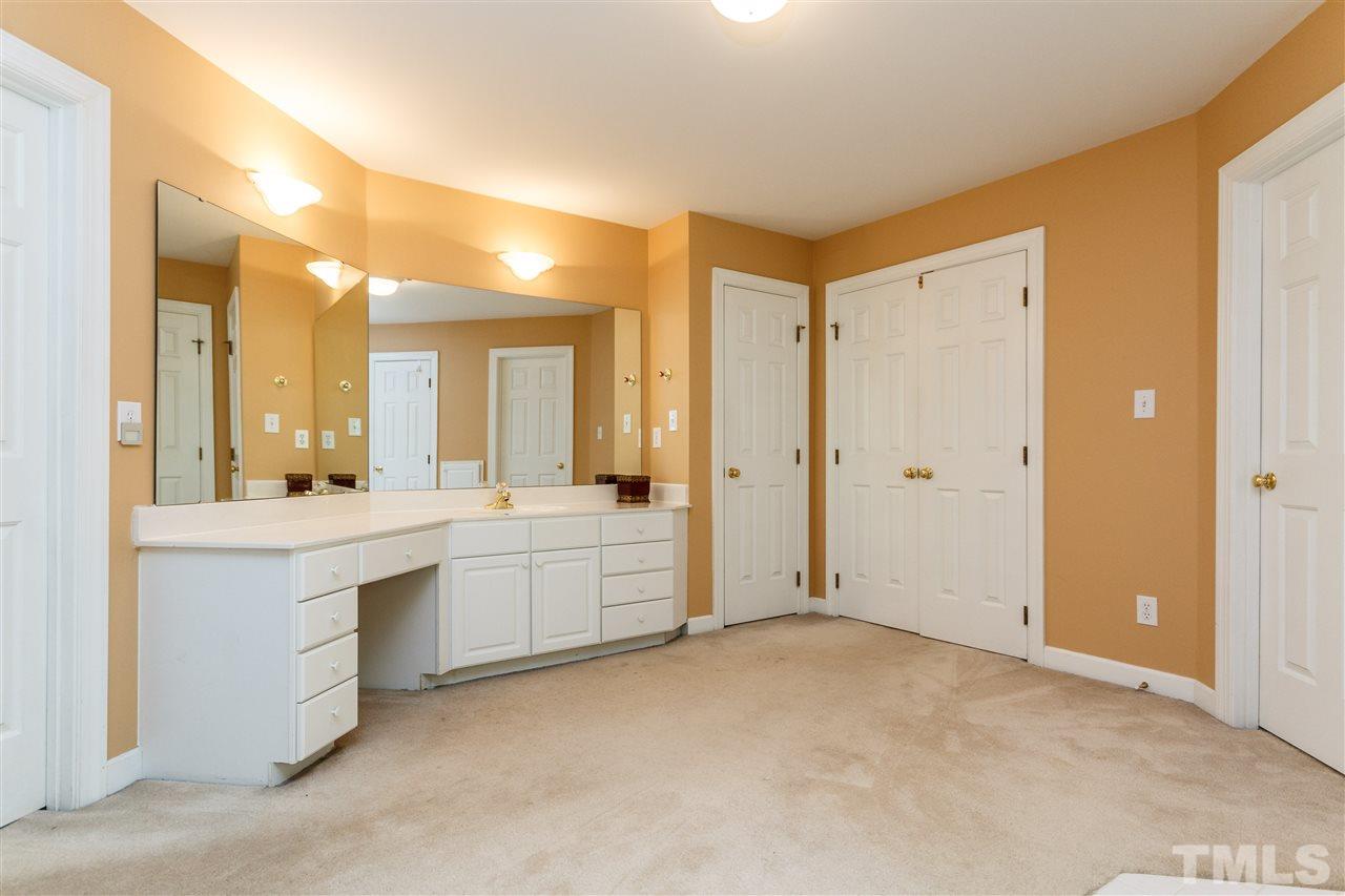 644 Pendleton Lake Road Raleigh, NC 27614 - Photo 22 of 25 a large white bathroom with a granite countertop sink mirror and a bathtub