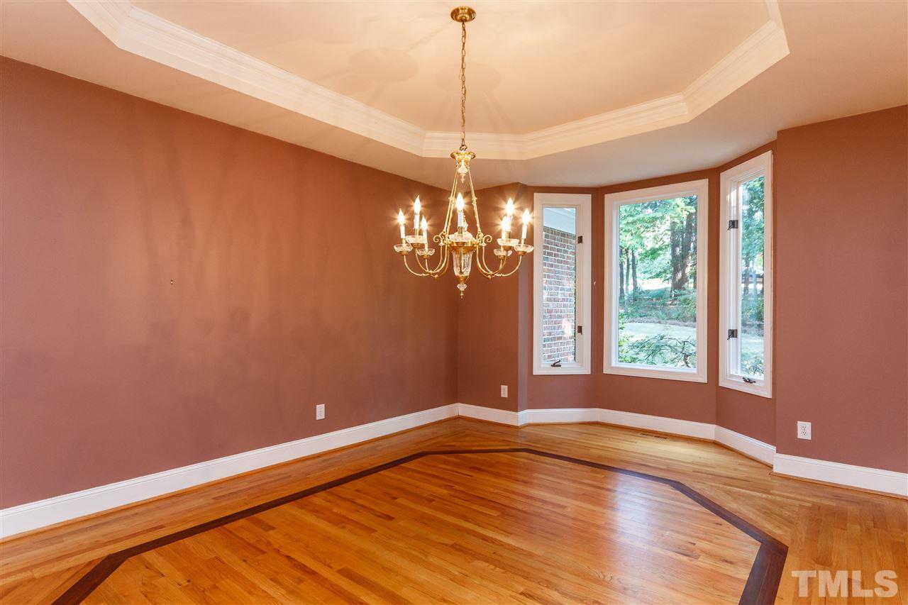 644 Pendleton Lake Road Raleigh, NC 27614 - Photo 5 of 25 a view of a room with window chandelier fan and wooden floor