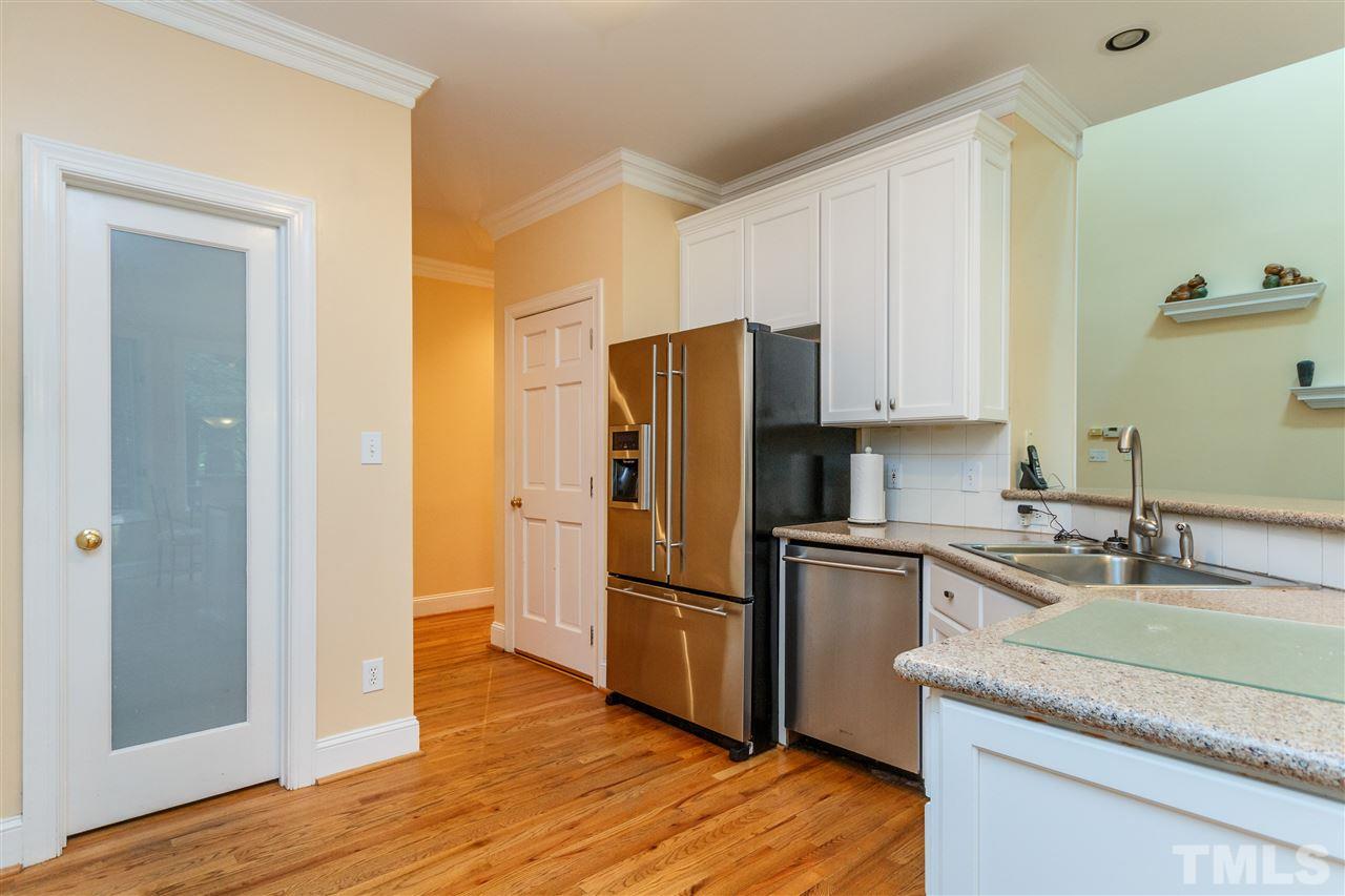 644 Pendleton Lake Road Raleigh, NC 27614 - Photo 9 of 25 a kitchen with a refrigerator cabinets and wooden floor