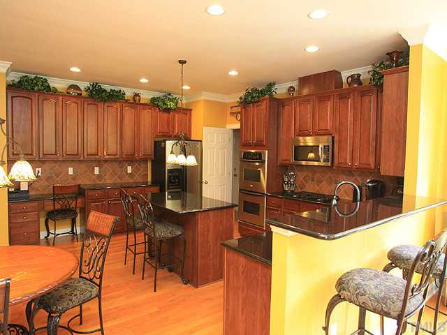 212 Quarryrock Road Holly Springs, NC 27540 - Photo 8 of 25 Dream kitchen with stainless, granite, double ovens, gas cook top, built in desk, and large island Kitchen