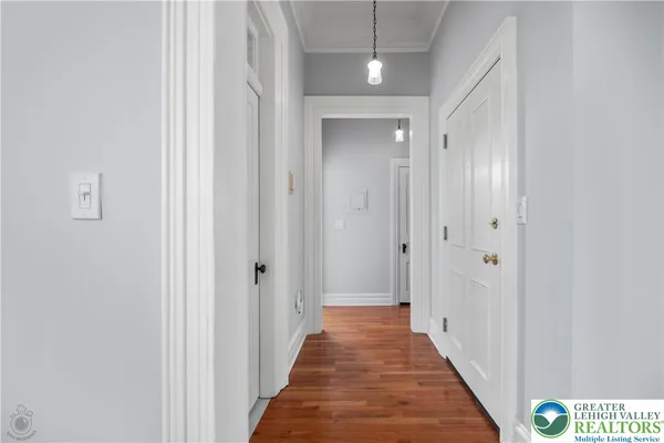a view of a hallway with wooden floor
