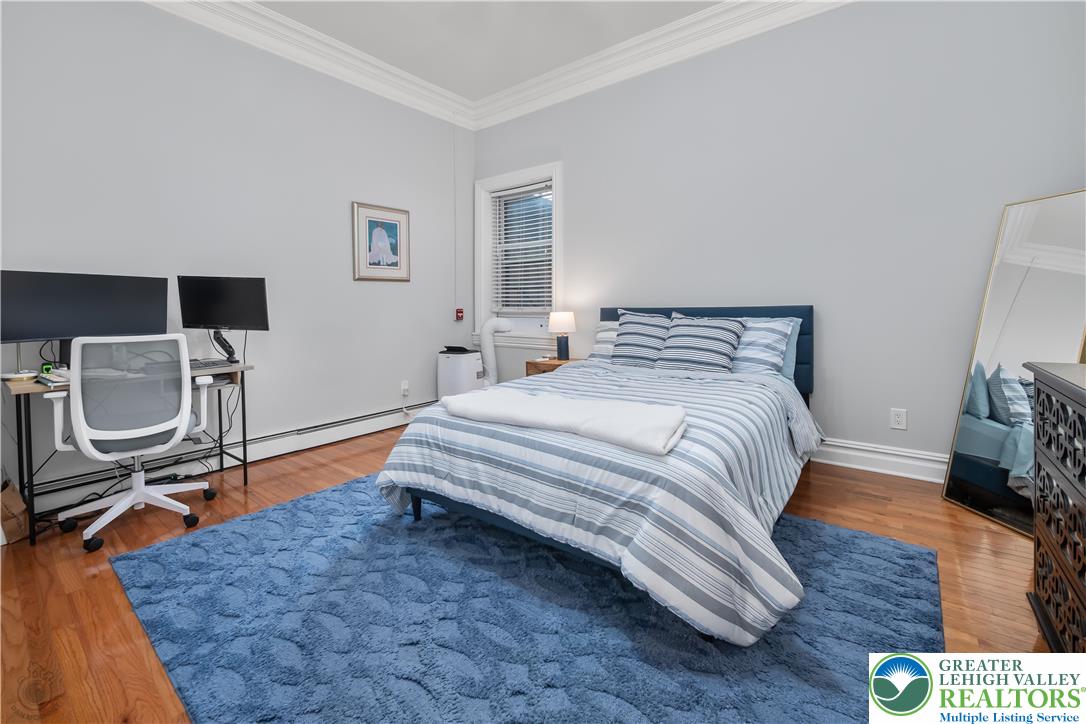 101 Northampton Street, Unit 2 Easton, PA 18042 - Photo 19 of 26 a bedroom with a bed a rug and wooden floor