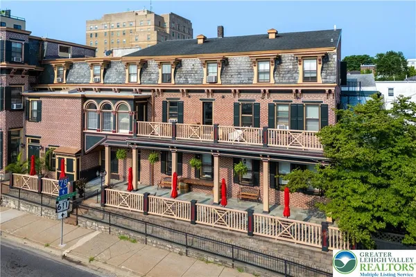 a front view of a building and car parked