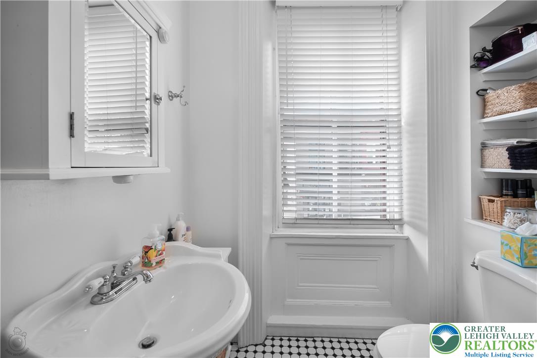 101 Northampton Street, Unit 2 Easton, PA 18042 - Photo 21 of 26 a bathroom with a sink a window and a toilet