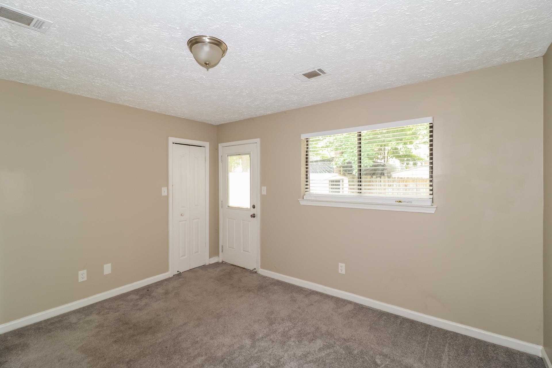 2156 Oldfield Drive Memphis, TN 38134 - Photo 11 of 17 a view of an empty room with window and closet area