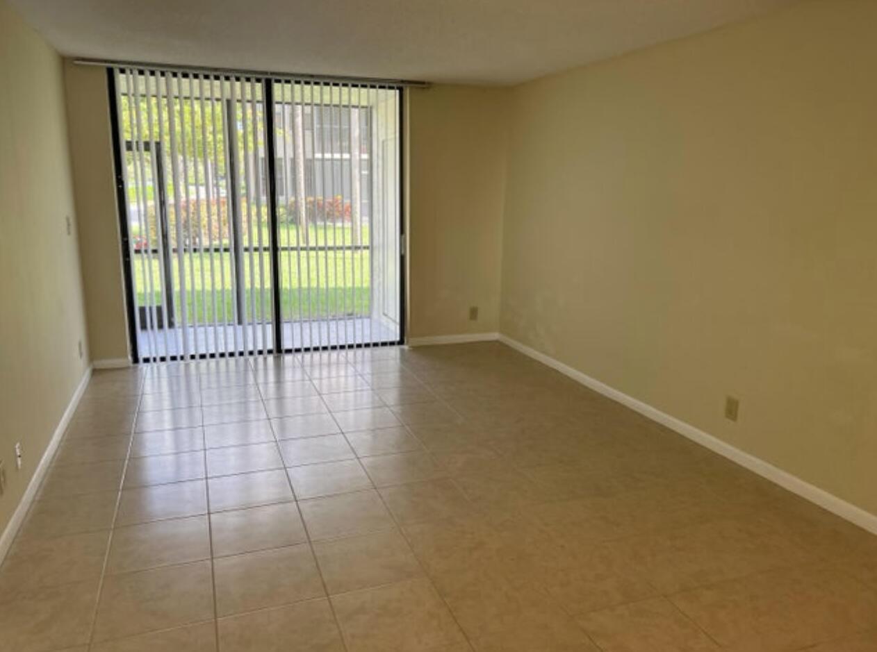 1256 South Military Trail, Unit 911 Deerfield Beach, FL 33442 - Photo 11 of 17 a view of a room with sliding glass door