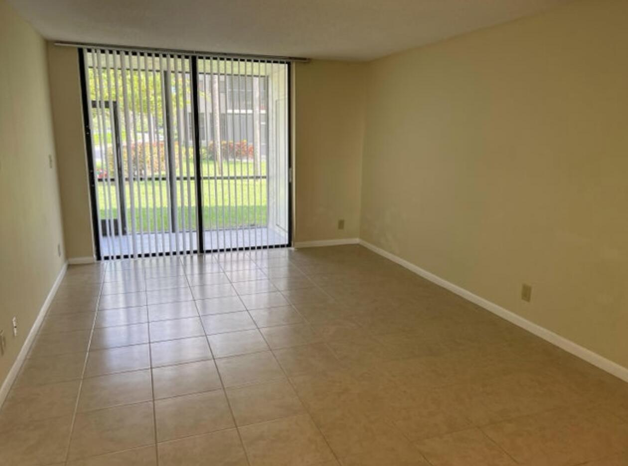 1256 South Military Trail, Unit 911 Deerfield Beach, FL 33442 - Photo 12 of 17 a view of a room with sliding glass door