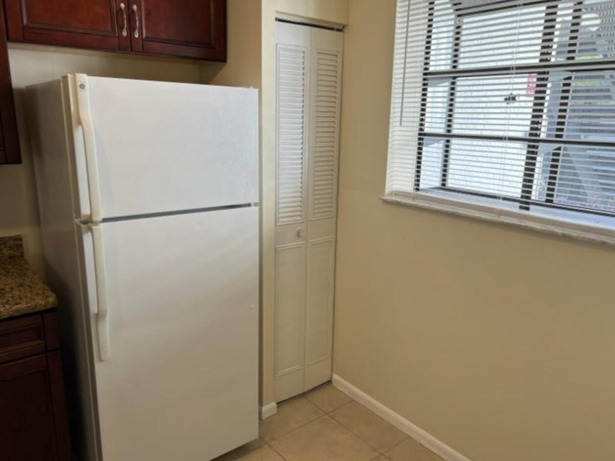 1256 South Military Trail, Unit 911 Deerfield Beach, FL 33442 - Photo 13 of 17 a white refrigerator freezer and a dishwasher