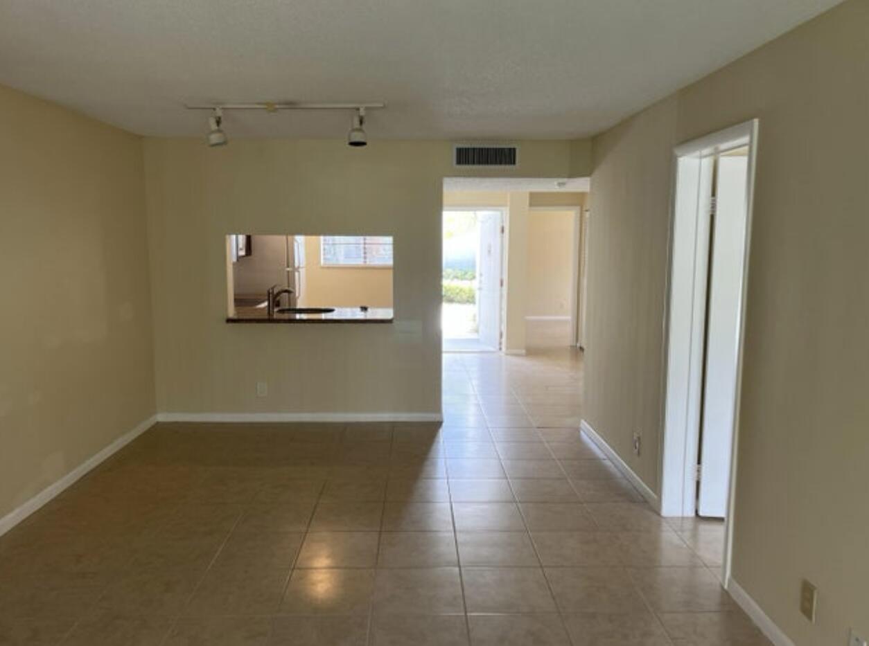 1256 South Military Trail, Unit 911 Deerfield Beach, FL 33442 - Photo 2 of 17 a view of a room with wooden floor and a window