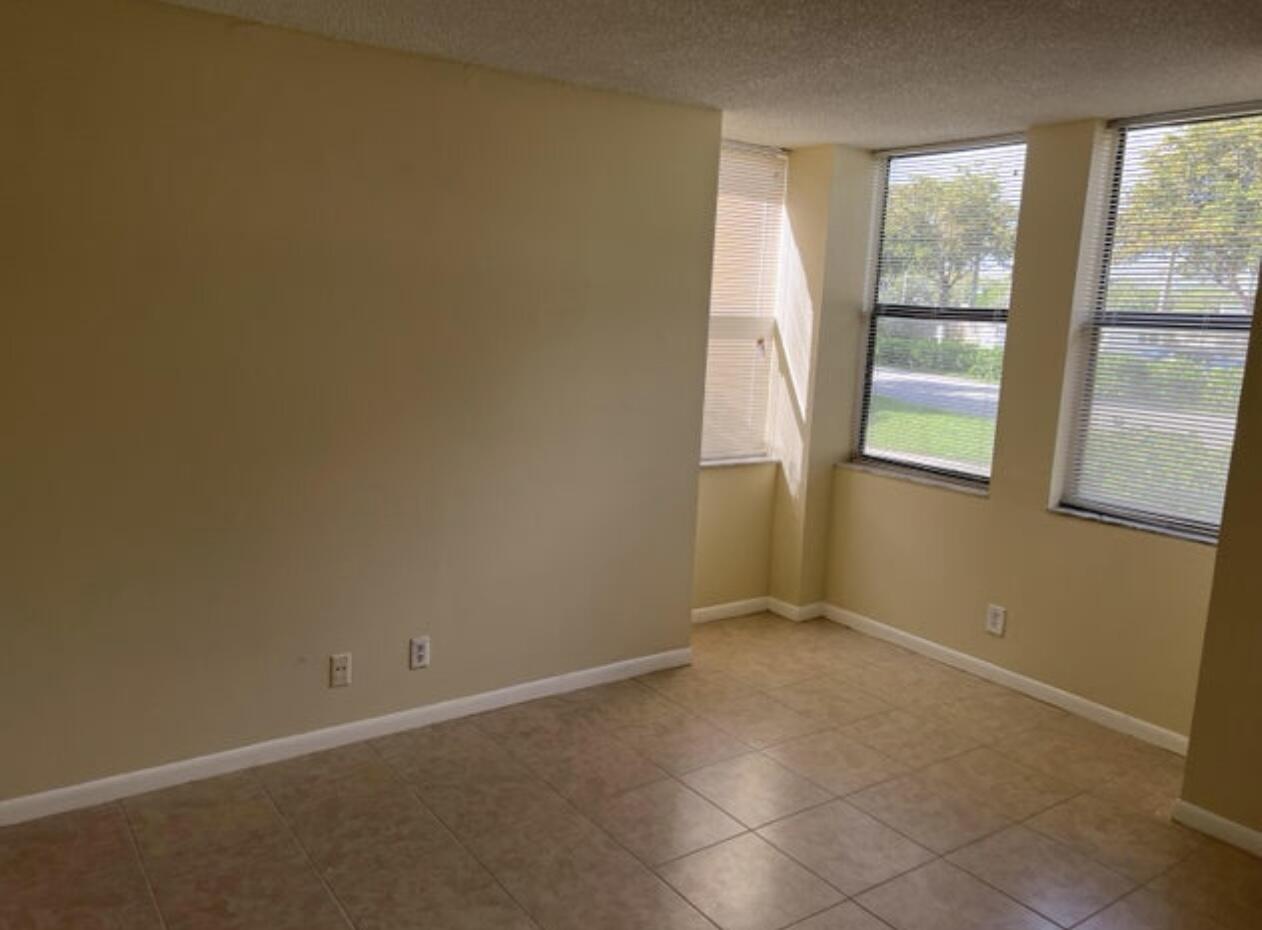 1256 South Military Trail, Unit 911 Deerfield Beach, FL 33442 - Photo 7 of 17 an empty room with a window