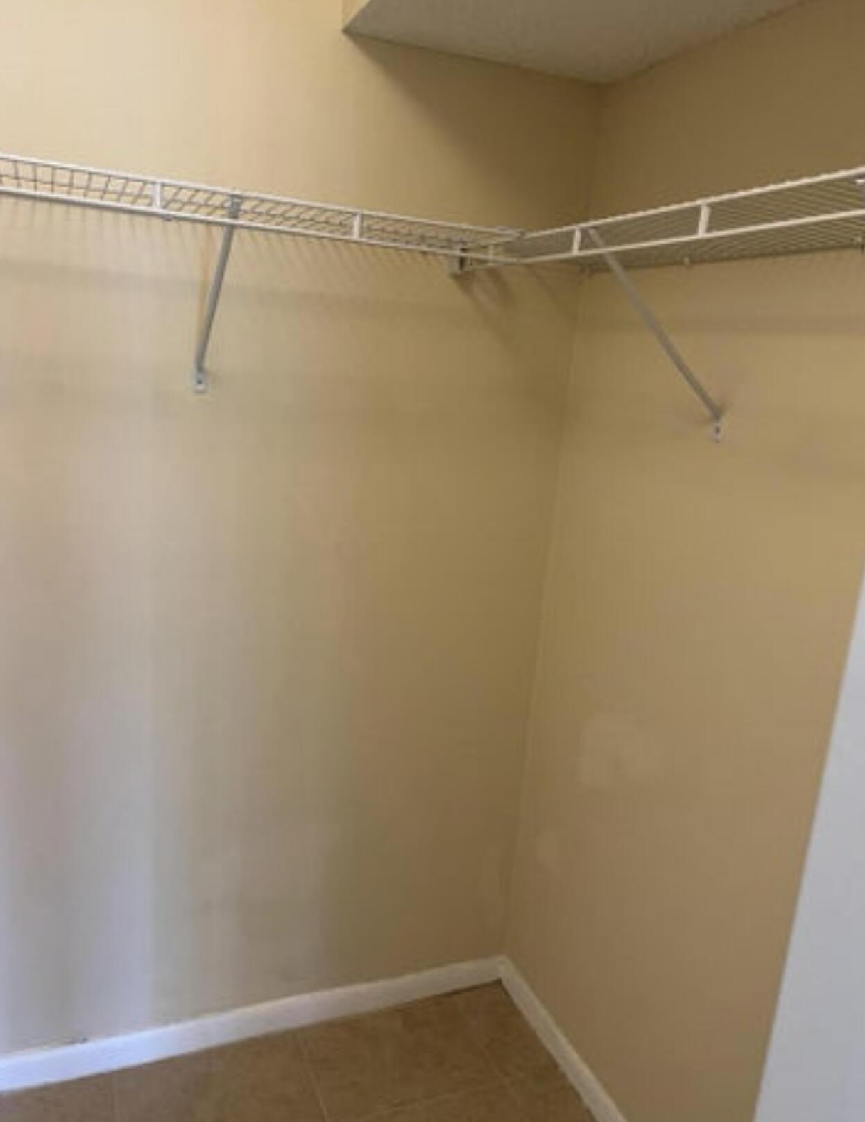 1256 South Military Trail, Unit 911 Deerfield Beach, FL 33442 - Photo 8 of 17 a view of a room with racks on the wall