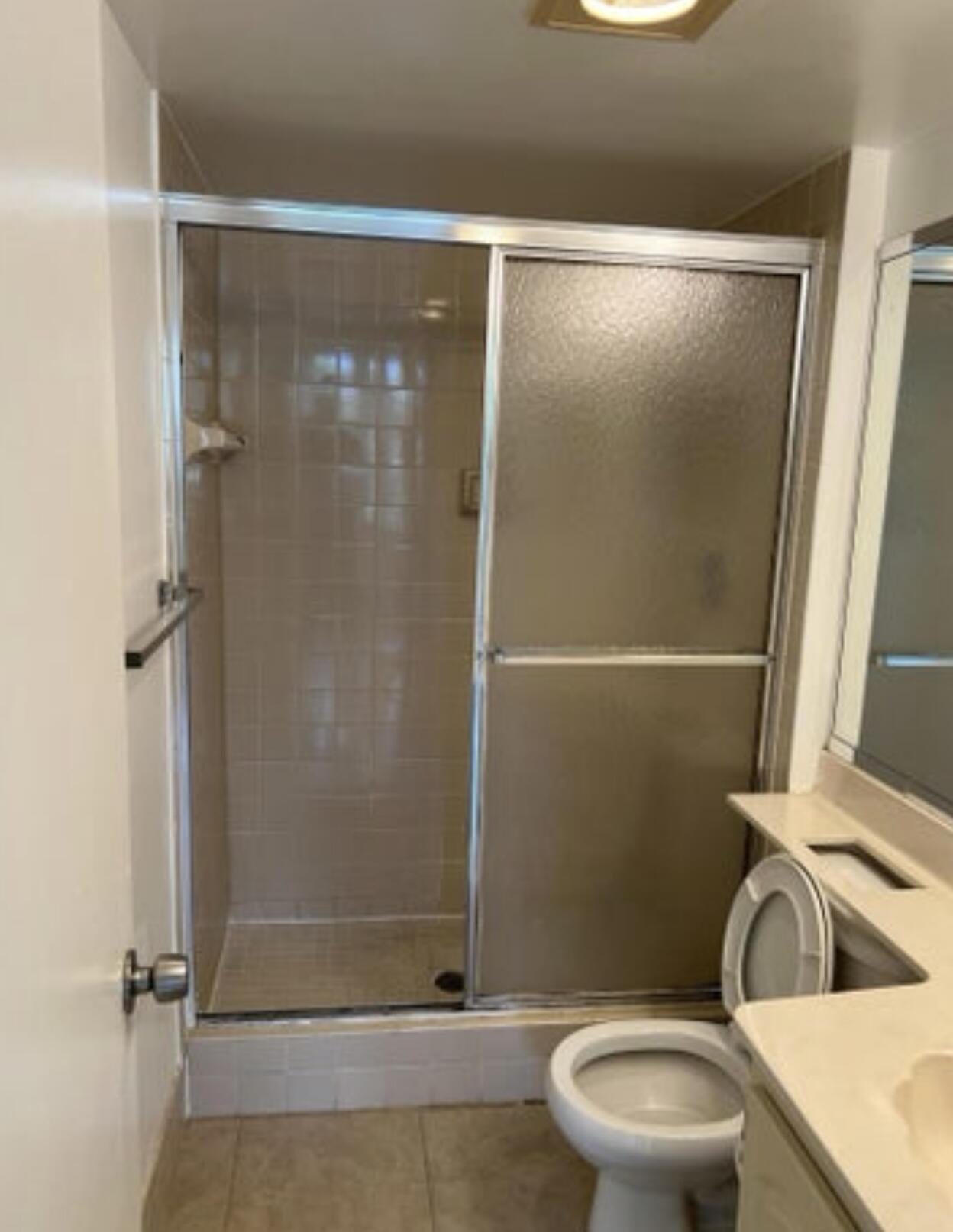1256 South Military Trail, Unit 911 Deerfield Beach, FL 33442 - Photo 9 of 17 a bathroom with a toilet and a shower
