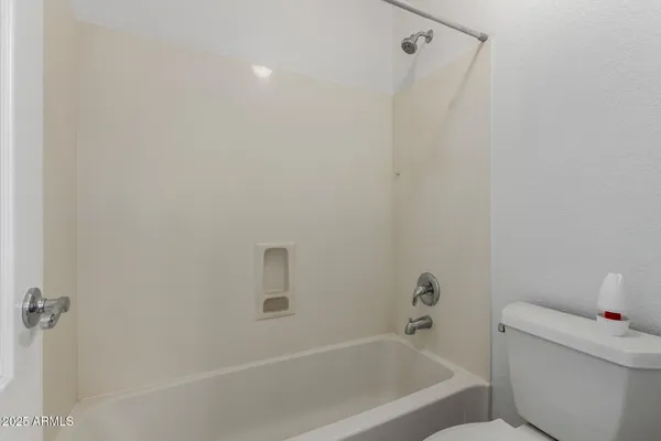 a bathroom with a bathtub and toilet