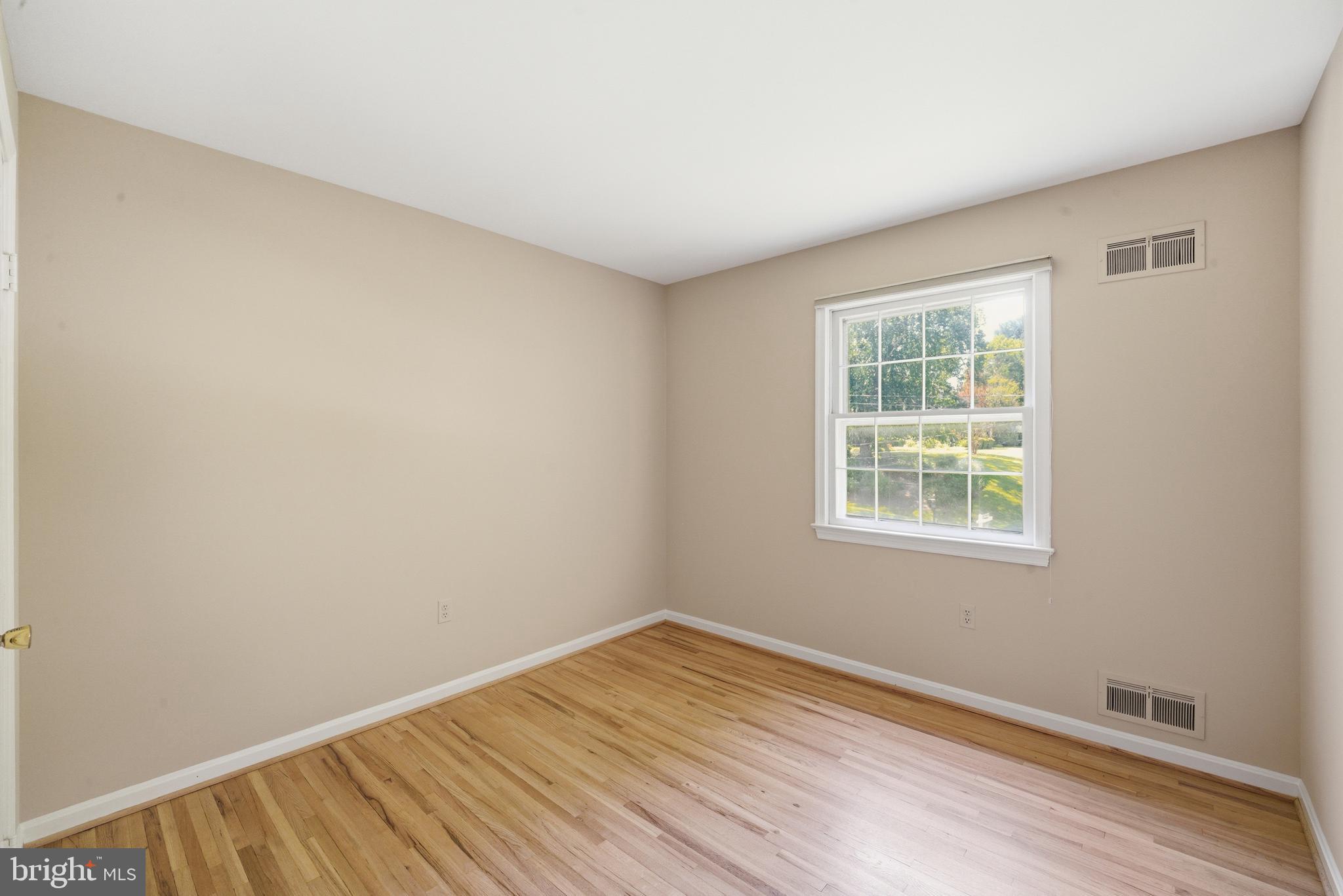 13309 Old Forge Road Silver Spring, MD 20904 - Photo 35 of 52 an empty room with wooden floor and windows