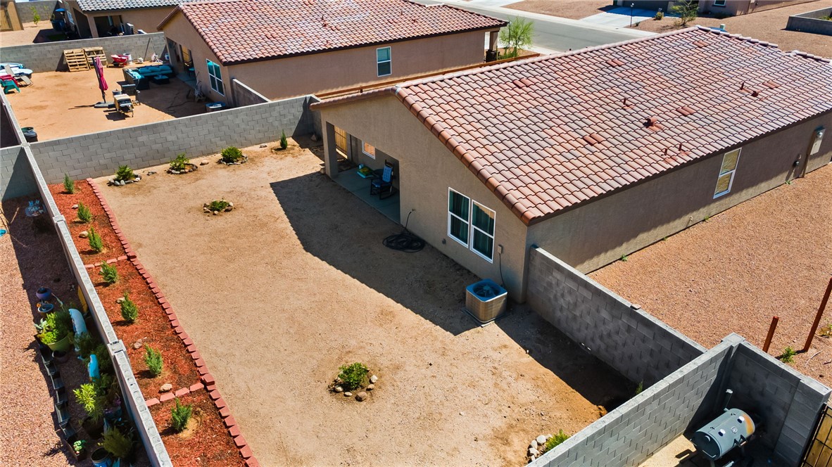 3623 East Andrea Drive Kingman, AZ 86409 - Photo 34 of 40 The property features a private backyard with a patio area and a low-maintenance landscape design
