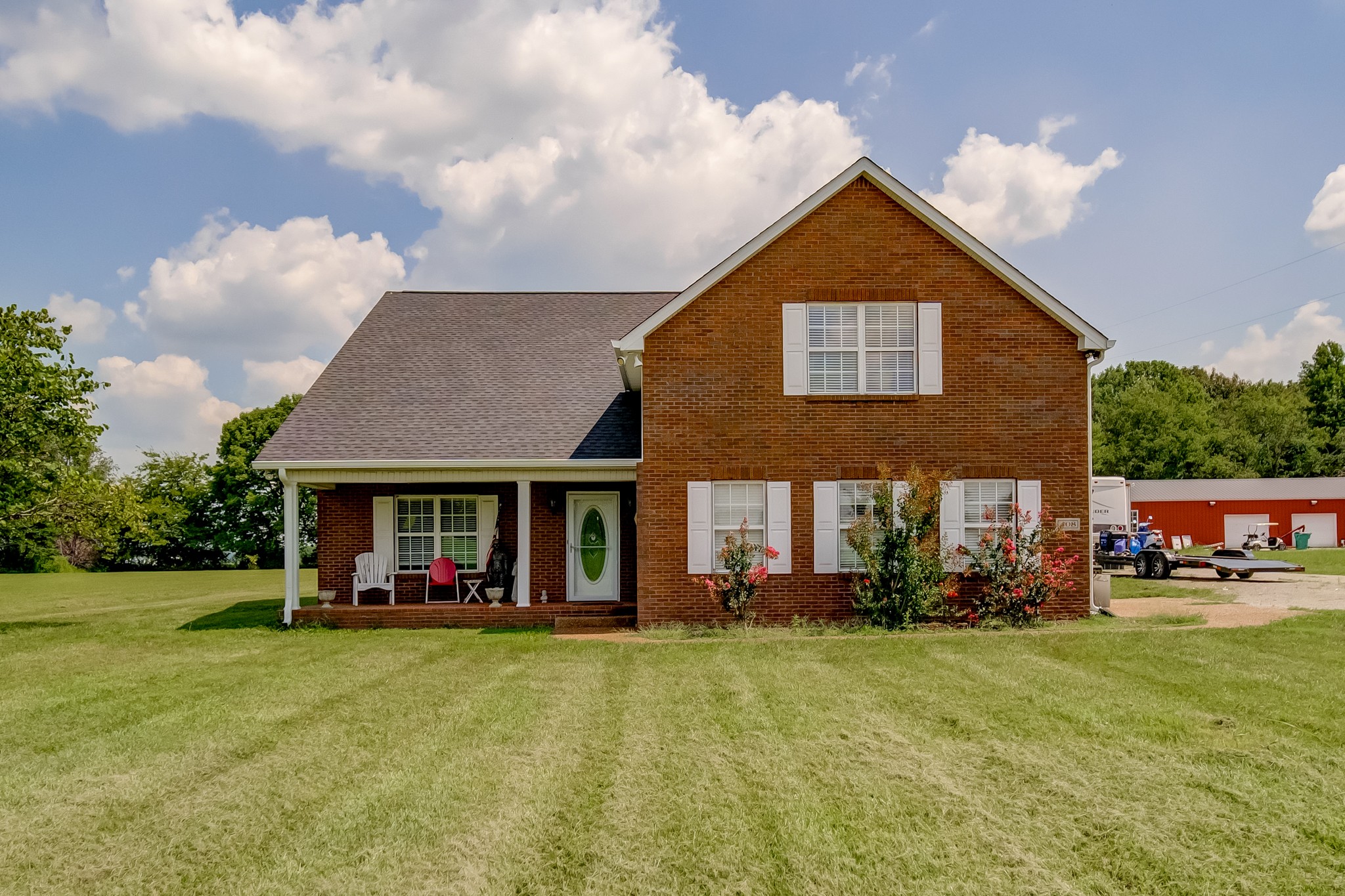 408 Cook Road Portland, TN 37148 - Photo 1 of 16 a front view of a house with garden