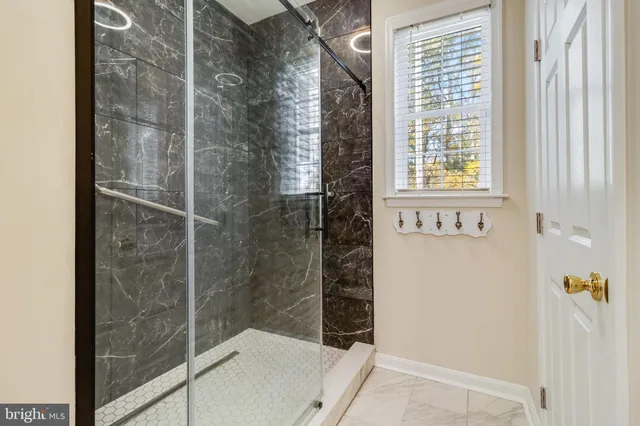 a kitchen with stainless steel appliances granite countertop a refrigerator a oven a stove and a sink