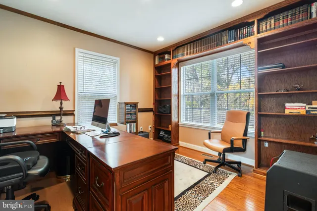 a kitchen with stainless steel appliances granite countertop a refrigerator a sink dishwasher a stove and a refrigerator with wooden floor