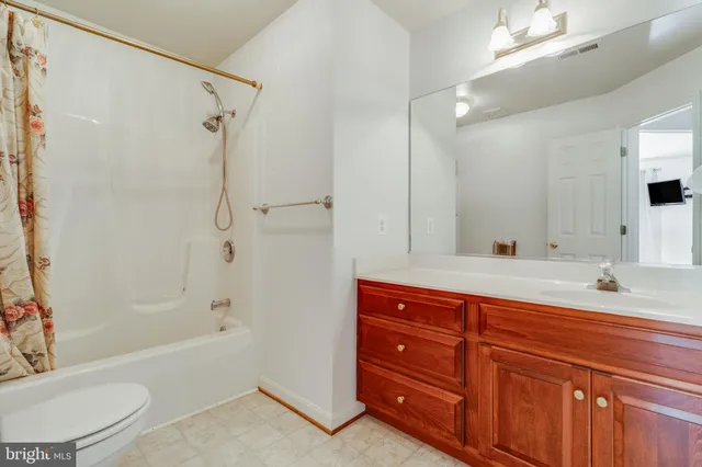a en suite bathroom with a tub and a large mirror next to a window