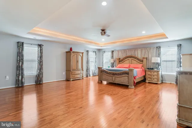 a kitchen with kitchen island granite countertop a stove oven and a refrigerator with cabinets