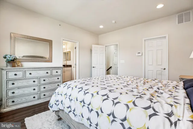 a large bedroom with a bed and a dresser