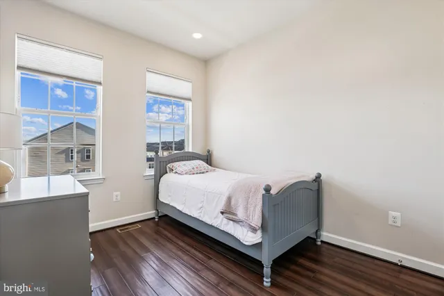 a bed room with a bed and windows