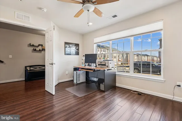 a view of a workspace with furniture and a window