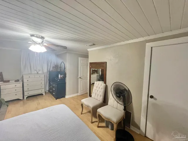 a bedroom with furniture and a window