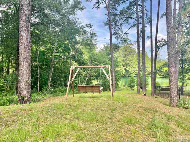 a view of outdoor space with deck and trees