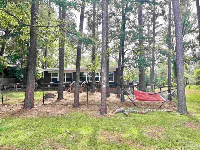 an aerial view of a house with a yard and lake view