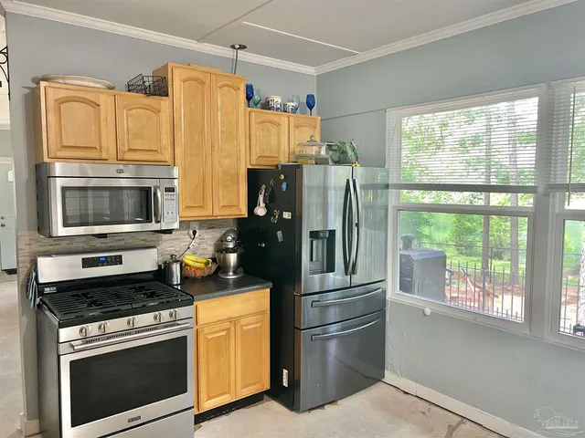 a kitchen with stainless steel appliances a refrigerator stove and microwave