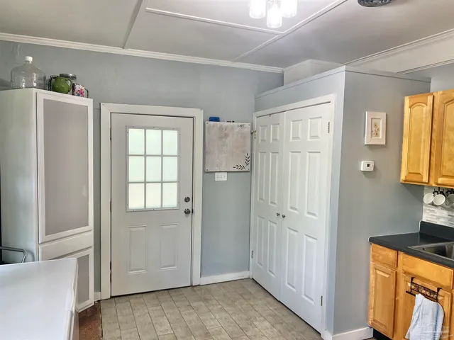 a view of walk in closet with window and bathroom
