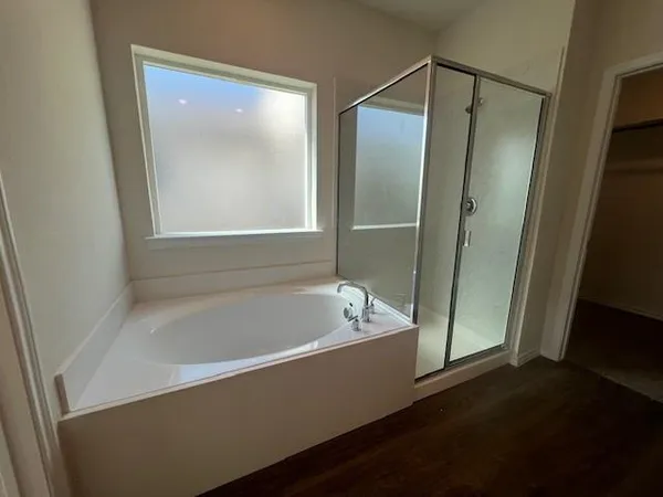 a bathroom with a bathtub and a shower
