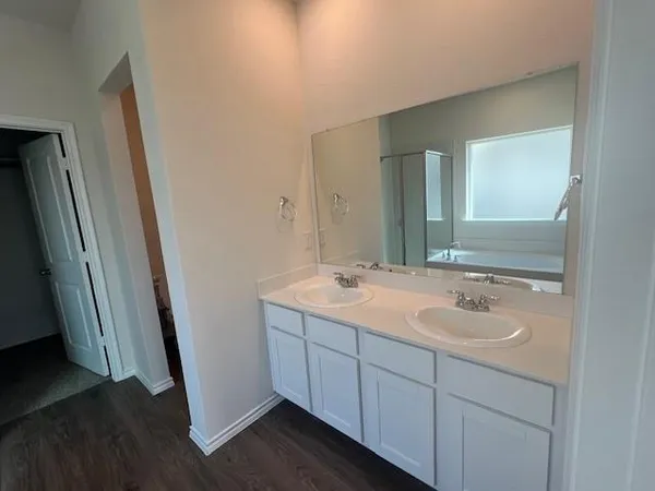 a bathroom with a double vanity sink and mirror