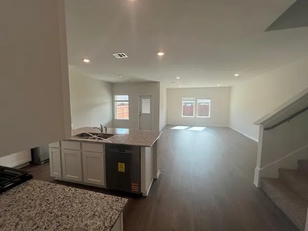 a living room with hard wood flooring and a couch