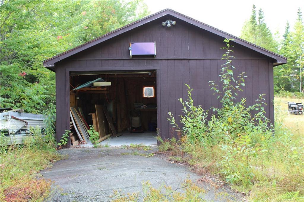 184 Ledge View Road West Forks, ME 04985 - Photo 31 of 49 Garage with overhead door. Room to...